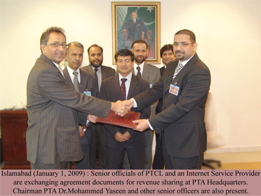 officals of ptcl and internet services provider are exchanging agreement documents  